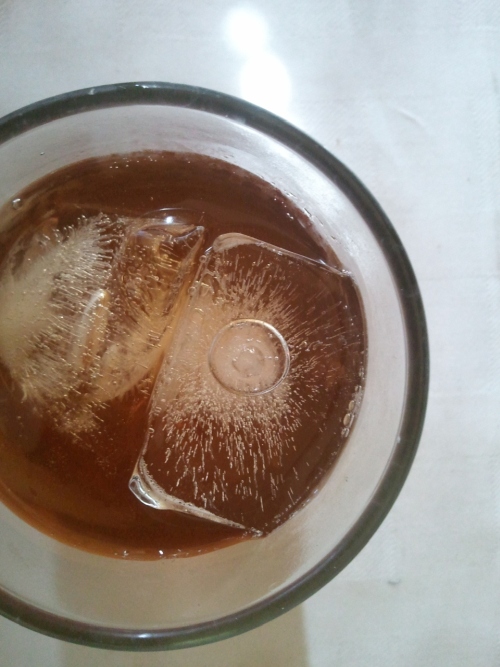 glass of ice tea, ice cube with a air pocket looks like an eye